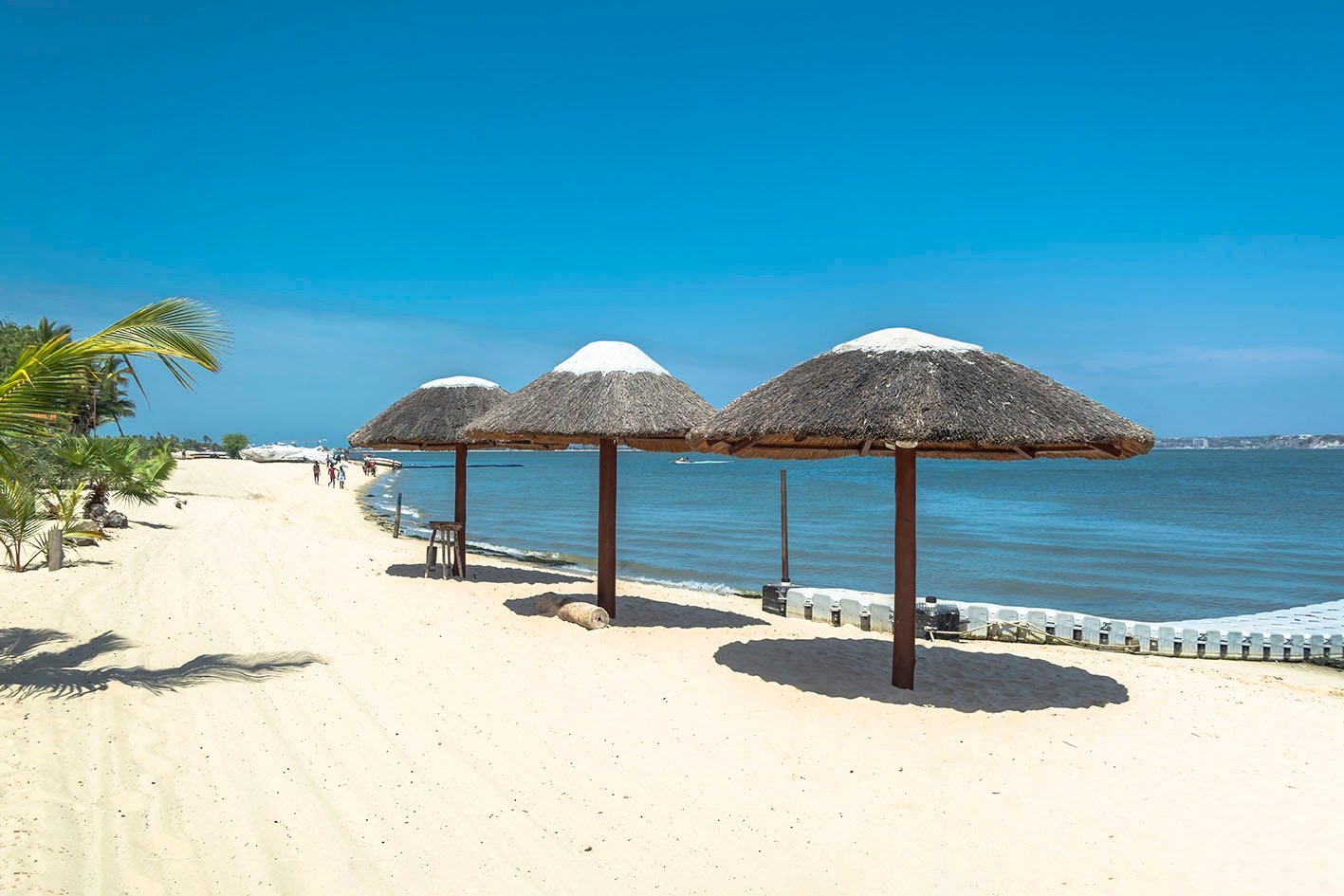 Three straw parasol, on tropical and paradisiac beach, in Angola